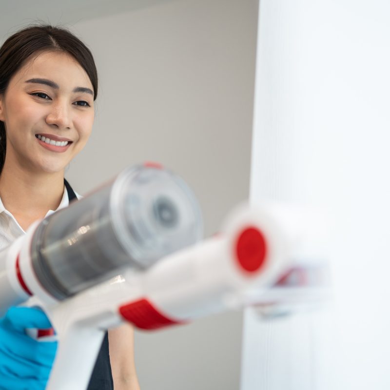 Asian cleaning service woman worker cleaning in living room at home. Asian cleaning service woman worker cleaning in living room at home.